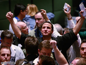 Traders signal offers in the S&P 500 stock index futures pit in Chicago after the Fed announcement Wednesday.