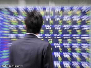 A man looks at a share prices board in Tokyo, where prices rebounded Wednesday.