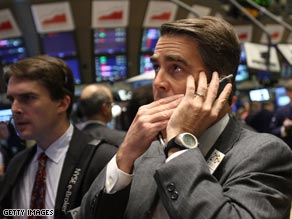 Wall Street traders watch the boards as the markets open Friday.
