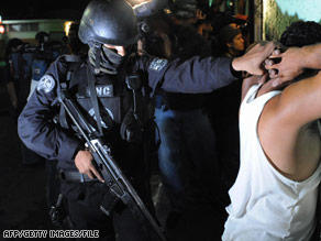 Police arrest a suspected MS-13 member during an April operation targeting the gang in El Salvador.