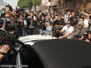 Photographers swarm a car carrying Britney Spears after a Los Angeles court appearance in October 2007.