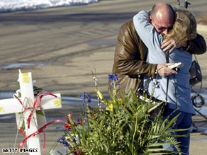 Relatives mourn after a gunman opened fire at a church meeting in Brookfield, Wisconsin, in 2005.