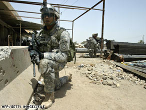 U.S. soldiers crouch at their positions during a mission in  Baquba, northeast of Baghdad, earlier this month.