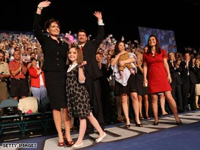 Bristol Palin, second from right, holds infant brother Trig at Friday's announcement of their mother's candidacy.