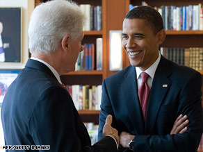 Bill Clinton and Barack Obama chat at Clinton's Harlem office.