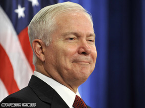 Barack Obama, right, listens as Robert Gates speaks December 1 in Chicago, Illinois.