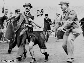 Pietri is helped toward the finishing line in 1908.