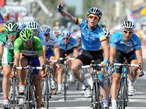 Cavendish (center) holds up three fingers to celebrate his third stage success in this year's Tour de France.