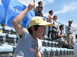 An American and a Cuban fan ham it up on the homestretch.