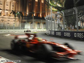 Massa hurtles round the Marina Bay circuit under the floodlights.