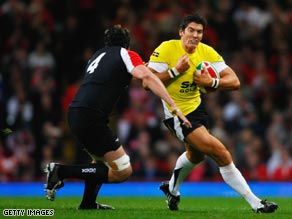 James Hook of Wales, right, is challenged by Tyler Hotson of Canada before going off with a knee injury.