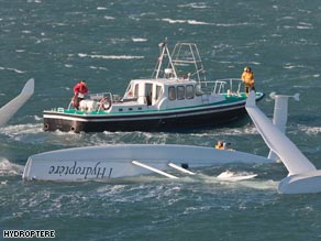 Capsized: French trimaran l'Hydroptere floats upside-down after flipping in high winds Sunday.