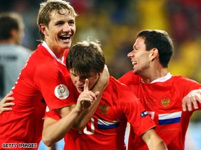 Andrei Arshavin, center, is mobbed by team-mates after securing Russia's place in the quarterfinals.