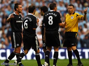 Terry (left) joins in the debate with referee Halsey after his dismissal.
