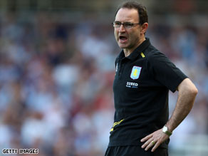 Martin O'Neill celebrates with Aston Villa team members