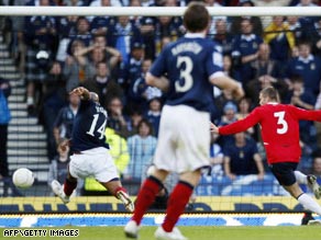 Substitute striker Chris Iwelumo, left, misses the opportunity to become a hero on his Scotland debut.