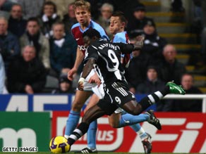 Martins fires the first of his two goals as Newcastle climbed off the foot of the Premier League.
