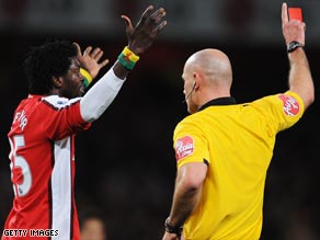 Arsenal's Adebayor protests his innocence after being sent off in the 1-1 home draw against Liverpool.