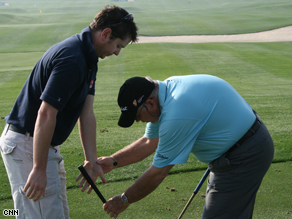 Top coach Butch Harmon shows CNN cameraman Andrew Waller how it's done.