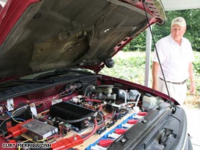 Larry Horsley's pickup has a set of neatly arranged electronics where his engine once was.