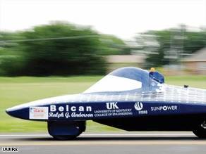 The University of Kentucky's solar car races along the road, on its way to the finish line.