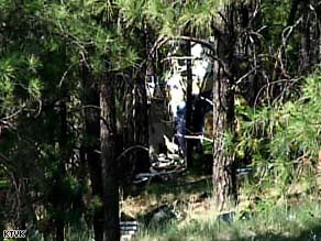 Rescue workers sift through wreckage from two medical helicopters that collided midair Sunday afternoon.