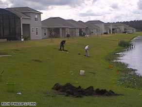 The Army Corps of Engineers digs up metal in search for live bombs in an Orlando neighborhood.