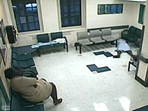 Surveillance video shows a woman lying on the hospital floor for almost an hour before anyone helped her.