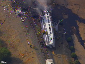 A commuter rail car lies on its side after a collision Friday near Los Angeles, California.