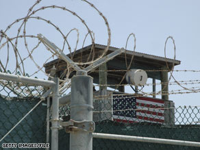 A guard tower is visible behind razor wire at the military facility at Guantanamo Bay, Cuba.