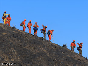 A fire crew works a scorched ridge on the eastern flank of the Sesnon fire on Tuesday.