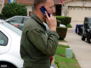 The pilot, whose name has not been released, on his cell phone after the crash.