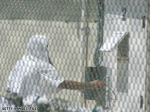 A detainee is seen through a fence in July at the U.S. prison camp at Guantanamo Bay, Cuba.