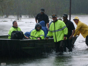 Rescue crews east of Baton Rouge had to navigate floodwaters and hundreds of fallen trees.