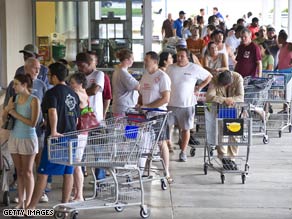 Fearing food shortages, customers line up to buy groceries in League City, Texas, on Sunday.