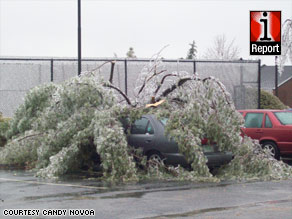 iReporter Candy Novoa says she woke up Friday to find a tree branch lying across her neighbor's car.