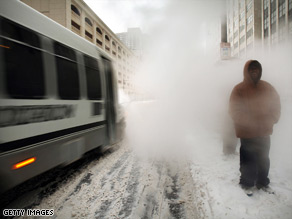 A worker shovels snow as the storm hits Chicago, Illinois, early Friday.