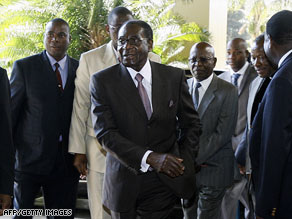 Zimbabwean President Robert Mugabe, right, meets South African President Thabo Mbeki, left, in Harare.