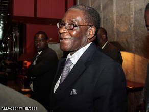 Zimbabwe President Robert Mugabe leaves a hotel where negotiations had been taking place Tuesday.