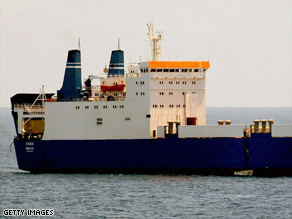 A photo from the USS Howard shows Somali pirates in small boats hijacking the MV Faina last week.
