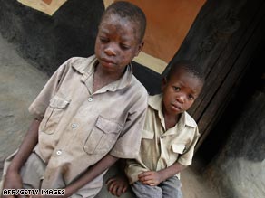 HIV-positive 13-year-old orphan Evans Mahlangu, left, and his brother Edmond, 8, had to jump Zimbabwe's border with Mozambique to get anti-retroviral drugs.