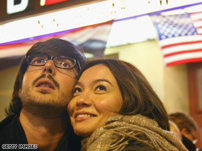 A German-speaking couple in Berlin watches the U.S. elections on TV late Tuesday night.