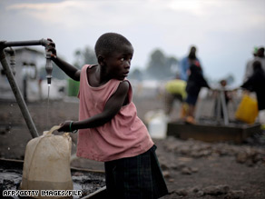 A girl fills a jug with water at the camp for internally displaced people in Kibati, Congo, on Thursday.