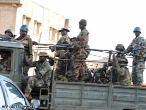 Soldiers patrol the streets in Jos after the riots.