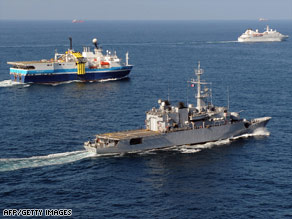 A French warship keeps guard over commercial vessels in the Gulf of Aden last month.