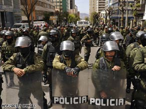 Riot police line up to block the passage of activists Monday in the Bolivian capital of La Paz.