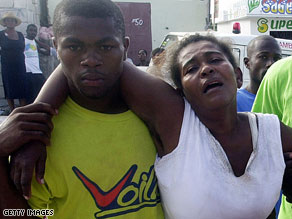 A mother anguishes over her missing child Monday near the scene of the school collapse in Petitionville.