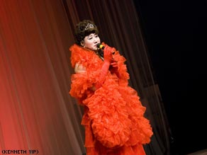 Teacher Zhang shows off his impressive drag wardrobe at home.
