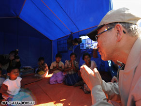 Ban Ki-moon makes a traditional gesture to a displaced family in the Kyondah village Thursday.