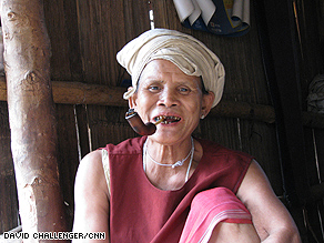 A Karen woman smokes a pipe. Boredom is one of the main problems for the refugees.